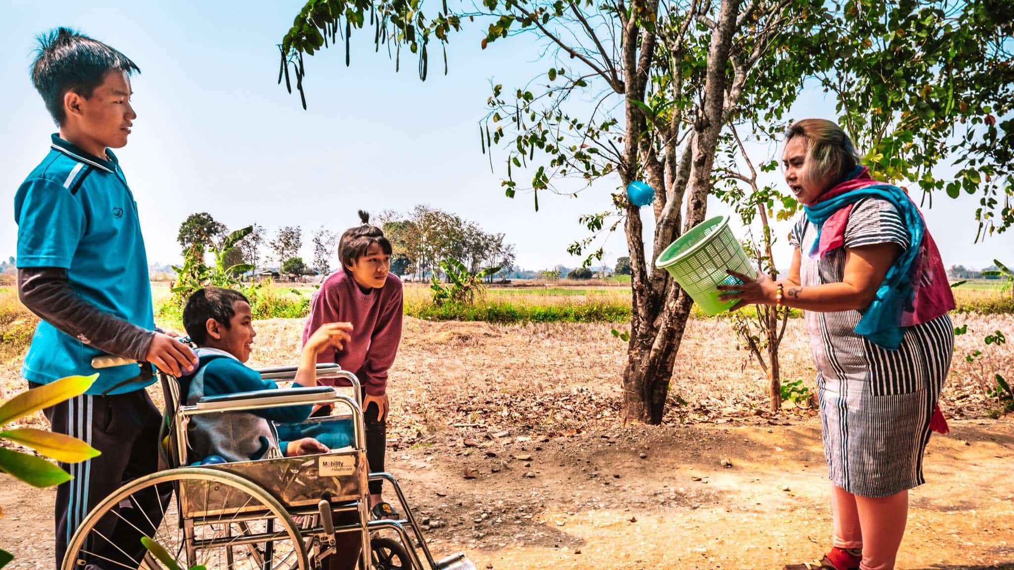 Krunam playing ball games with three children in Thailand