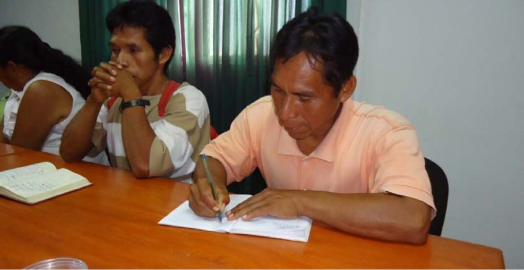 2012: Indigenous community leaders with AFIMAD, a cooperative of native communities in Madre de Dios Peru signs 2012 Not For Sale + AFIMAD development plan.